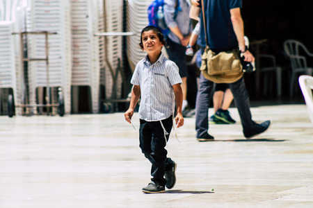 Jerusalem Israel June 24, 2019 View of young Israeli child walking front the Western wall in the Old city of Jerusalem in the afternoonのeditorial素材