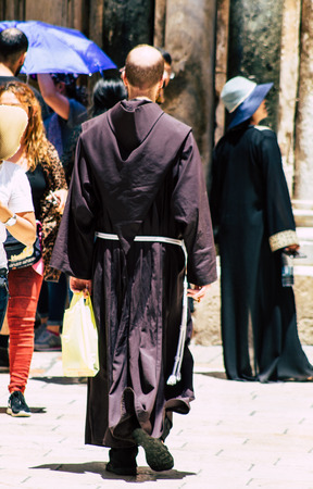Jerusalem Israel June 24, 2019 View of unknown Catholic priest walking front the holy church in the Old city of Jerusalem in the afternoonのeditorial素材
