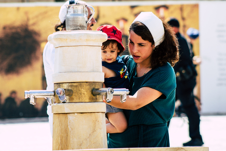 Jerusalem Israel July 2, 2019 View of unknown Israeli people drinking to the fountain located at the Western wall in the Old city of Jerusalem in the afternoonのeditorial素材