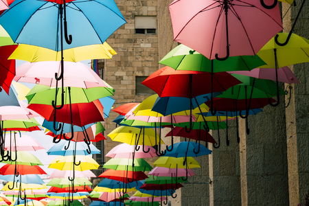Jerusalem Israel July 2, 2019 Closeup of colorful umbrellas suspended by barely visible string over Yoel Moshe Solomon Street in the historic Nachalat Shiva district in Jerusalemのeditorial素材