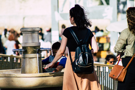 Jerusalem Israel July 2, 2019 View of unknown Israeli people drinking to the fountain located at the Western wall in the Old city of Jerusalem in the afternoonのeditorial素材