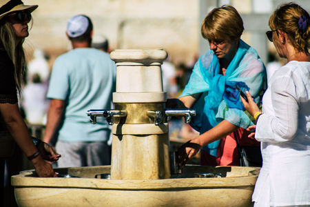 Jerusalem Israel July 2, 2019 View of unknown Israeli people drinking to the fountain located at the Western wall in the Old city of Jerusalem in the afternoonのeditorial素材