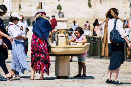 Jerusalem Israel July 2, 2019 View of unknown Israeli people drinking to the fountain located at the Western wall in the Old city of Jerusalem in the afternoonのeditorial素材