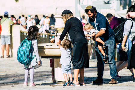 Jerusalem Israel July 2, 2019 View of unknown Israeli people drinking to the fountain located at the Western wall in the Old city of Jerusalem in the afternoonのeditorial素材
