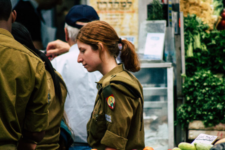 Jerusalem Israel July 3, 2019 View of unknown Israeli soldier walking and shopping at the Mahane...