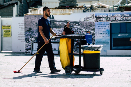 Jerusalem Israel July 3, 2019 View of unknown cleaner walking front the Western Wall at the Old city of Jerusalem in the morningのeditorial素材