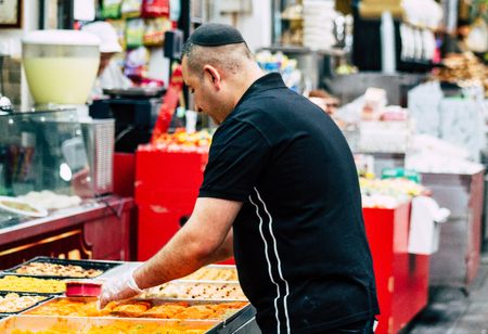 Jerusalem Israel July 3, 2019 View of unknown Israeli seller working at Mahane Yehuda Market in Jerusalem in the morningのeditorial素材