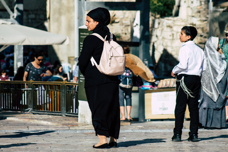Jerusalem Israel July 4, 2019 View of unknown Israeli people walking front the Western wall in the Old city of Jerusalem in the afternoonのeditorial素材