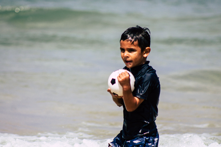 Tel Aviv Israel July 6, 2019 View of unknown Israeli child having fun on the beach of Tel Aviv during a sunny day in the afternoonのeditorial素材