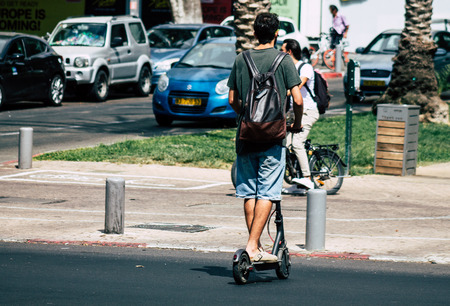 Tel Aviv Israel July 7, 2019 View of unknown Israeli people rolling with a electric scooter in the streets of Tel Aviv in the afternoonのeditorial素材