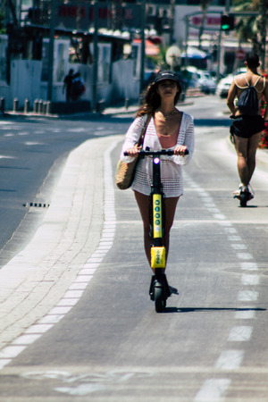 Tel Aviv Israel July 7, 2019 View of unknown Israeli people rolling with a electric scooter in the streets of Tel Aviv in the afternoonのeditorial素材