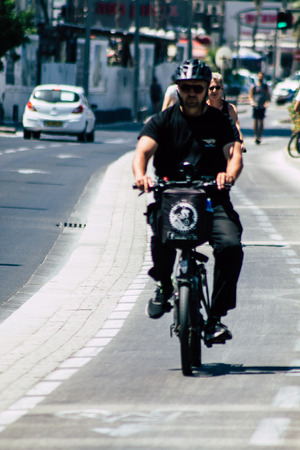 Tel Aviv Israel July 8, 2019 View of unknown Israeli people rolling with a bicycle in the streets of Tel Aviv in the afternoonのeditorial素材
