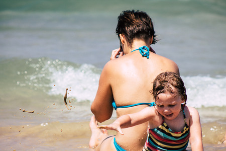 Tel Aviv Israel July 6, 2019 View of unknown Israeli child having fun on the beach of Tel Aviv during a sunny day in the afternoonのeditorial素材