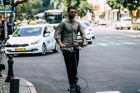 Tel Aviv Israel July 7, 2019 View of unknown Israeli people rolling with a electric scooter in the streets of Tel Aviv in the afternoonのeditorial素材