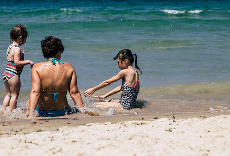Tel Aviv Israel July 6, 2019 View of unknown Israeli child having fun on the beach of Tel Aviv during a sunny day in the afternoonのeditorial素材