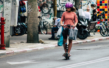 Tel Aviv Israel July 7, 2019 View of unknown Israeli people rolling with a electric scooter in the streets of Tel Aviv in the afternoonのeditorial素材