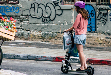Tel Aviv Israel July 7, 2019 View of unknown Israeli people rolling with a electric scooter in the streets of Tel Aviv in the afternoonのeditorial素材