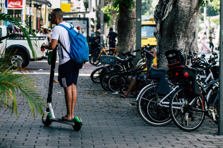 Tel Aviv Israel July 7, 2019 View of unknown Israeli people rolling with a electric scooter in the streets of Tel Aviv in the afternoonのeditorial素材