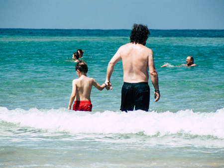 Tel Aviv Israel July 11, 2019 View of unknown Israeli people having fun on the beach of Tel Aviv during a sunny day in the afternoonのeditorial素材