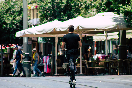 Jerusalem Israel July 6, 2019 View of unknown Israeli people rolling with a electric scooter in Jaffa street in Jerusalem in the afternoonのeditorial素材