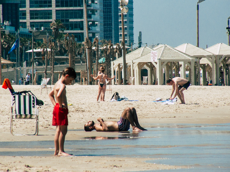 Tel Aviv Israel July 11, 2019 View of unknown Israeli people having fun on the beach of Tel Aviv during a sunny day in the afternoonのeditorial素材
