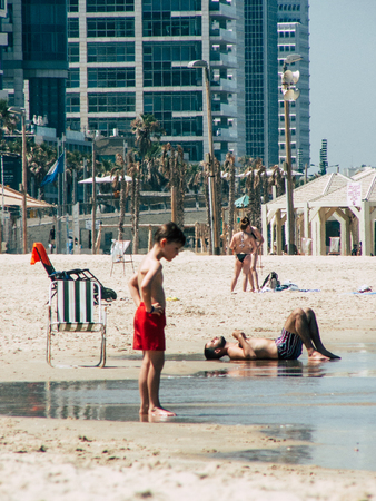 Tel Aviv Israel July 11, 2019 View of unknown Israeli people having fun on the beach of Tel Aviv during a sunny day in the afternoonのeditorial素材