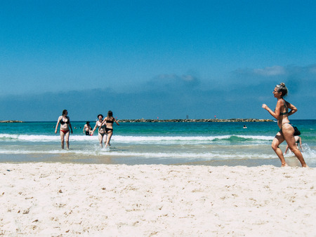 Tel Aviv Israel July 11, 2019 View of unknown Israeli people having fun on the beach of Tel Aviv during a sunny day in the afternoonのeditorial素材