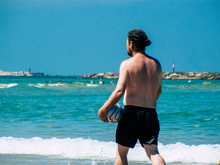 Tel Aviv Israel July 11, 2019 View of unknown Israeli people having fun on the beach of Tel Aviv during a sunny day in the afternoonのeditorial素材
