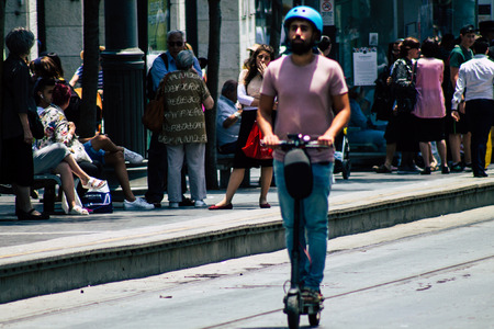 Jerusalem Israel July 6, 2019 View of unknown Israeli people rolling with a electric scooter in Jaffa street in Jerusalem in the afternoonのeditorial素材