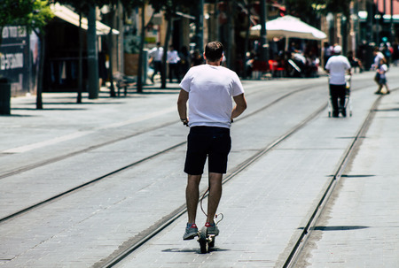 Jerusalem Israel July 6, 2019 View of unknown Israeli people rolling with a electric scooter in...
