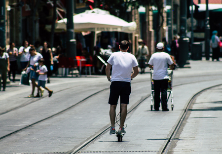 Jerusalem Israel July 6, 2019 View of unknown Israeli people rolling with a electric scooter in Jaffa street in Jerusalem in the afternoonのeditorial素材