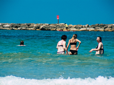 Tel Aviv Israel July 11, 2019 View of unknown Israeli people having fun on the beach of Tel Aviv during a sunny day in the afternoonのeditorial素材