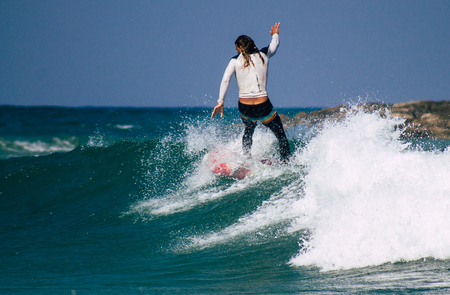 Tel Aviv Israel July 9, 2019 View of unknown Israeli people practicing surfing on Tel Aviv beach in the morningのeditorial素材