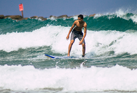 Tel Aviv Israel July 9, 2019 View of unknown Israeli people practicing surfing on Tel Aviv beach in...