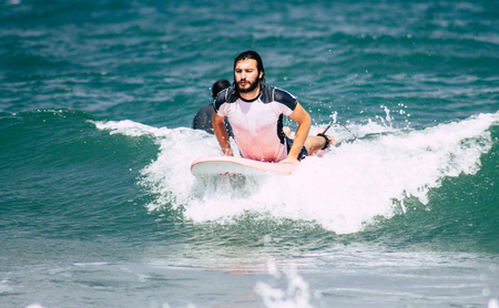 Tel Aviv Israel July 9, 2019 View of unknown Israeli people practicing surfing on Tel Aviv beach in the morningのeditorial素材