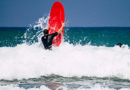 Tel Aviv Israel July 9, 2019 View of unknown Israeli people practicing surfing on Tel Aviv beach in the morningのeditorial素材