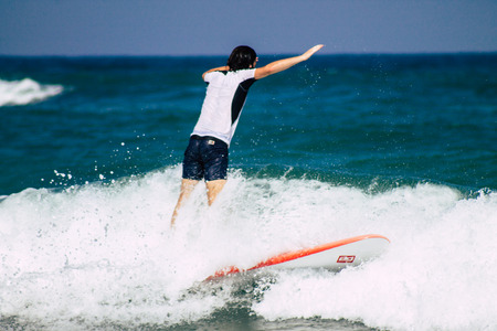 Tel Aviv Israel July 9, 2019 View of unknown Israeli people practicing surfing on Tel Aviv beach in the morningのeditorial素材