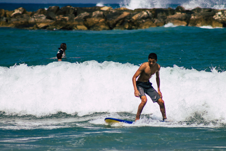 Tel Aviv Israel July 9, 2019 View of unknown Israeli people practicing surfing on Tel Aviv beach in the morningのeditorial素材