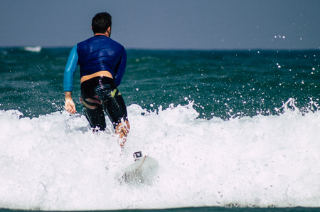Tel Aviv Israel July 9, 2019 View of unknown Israeli people practicing surfing on Tel Aviv beach in the morningのeditorial素材
