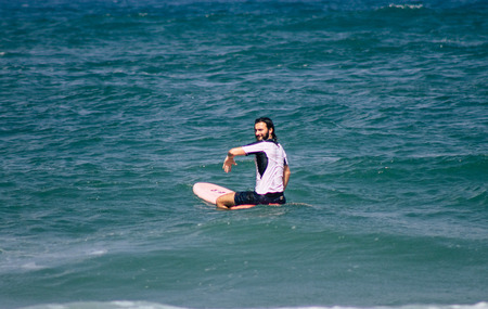 Tel Aviv Israel July 9, 2019 View of unknown Israeli people practicing surfing on Tel Aviv beach in the morningのeditorial素材