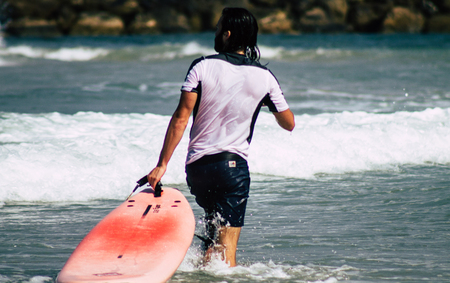 Tel Aviv Israel July 9, 2019 View of unknown Israeli people practicing surfing on Tel Aviv beach in the morningのeditorial素材