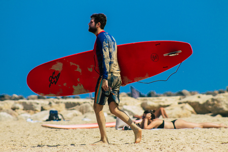 Tel Aviv Israel July 9, 2019 View of unknown Israeli people practicing surfing on Tel Aviv beach in the morningのeditorial素材