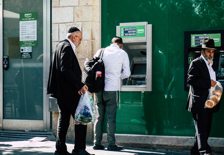 Tel Aviv Israel July 9, 2019 Closeup of a Israeli people using a ATM in the streets of Tel Aviv in the afternoonのeditorial素材