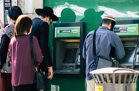 Tel Aviv Israel July 9, 2019 Closeup of a Israeli people using a ATM in the streets of Tel Aviv in the afternoonのeditorial素材