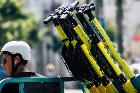 Tel Aviv Israel August 2, 2019 View of unknown Israeli people collecting electric scooters in the streets of Tel Aviv in the afternoonのeditorial素材