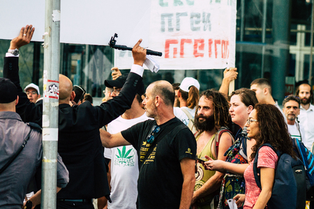 Tel Aviv Israel August 1, 2019 View of unknown Israeli people taking part in a political demonstration against the government of Benjamin Netanyahu in front of Azrieli Center in Tel Aviv in the early eveningのeditorial素材