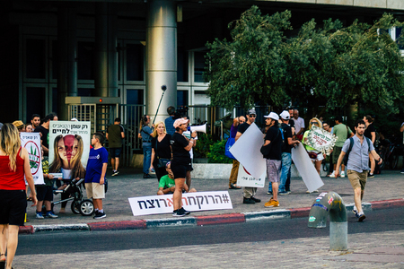 Tel Aviv Israel August 1, 2019 View of Israeli people taking part in a political demonstration against the government of Benjamin Netanyahu in front of Azrieli Center in Tel Aviv in the early eveningのeditorial素材