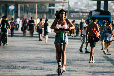 Tel Aviv Israel August 2, 2019 View of unknown Israeli people rolling with a electric scooters in the streets of Tel Aviv in the afternoonのeditorial素材