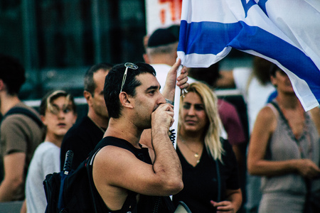 Tel Aviv Israel August 1, 2019 View of Israeli people taking part in a political demonstration against the government of Benjamin Netanyahu in front of Azrieli Center in Tel Aviv in the early eveningのeditorial素材