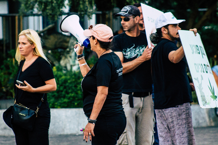 Tel Aviv Israel August 1, 2019 View of Israeli people taking part in a political demonstration against the government of Benjamin Netanyahu in front of Azrieli Center in Tel Aviv in the early eveningのeditorial素材